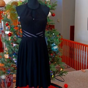 Escape black cocktail dress. New with Tag see-through waist. Size 6. Gorgeous